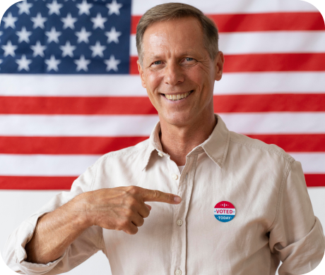 Man wearing a campaign shirt in front of an American flag