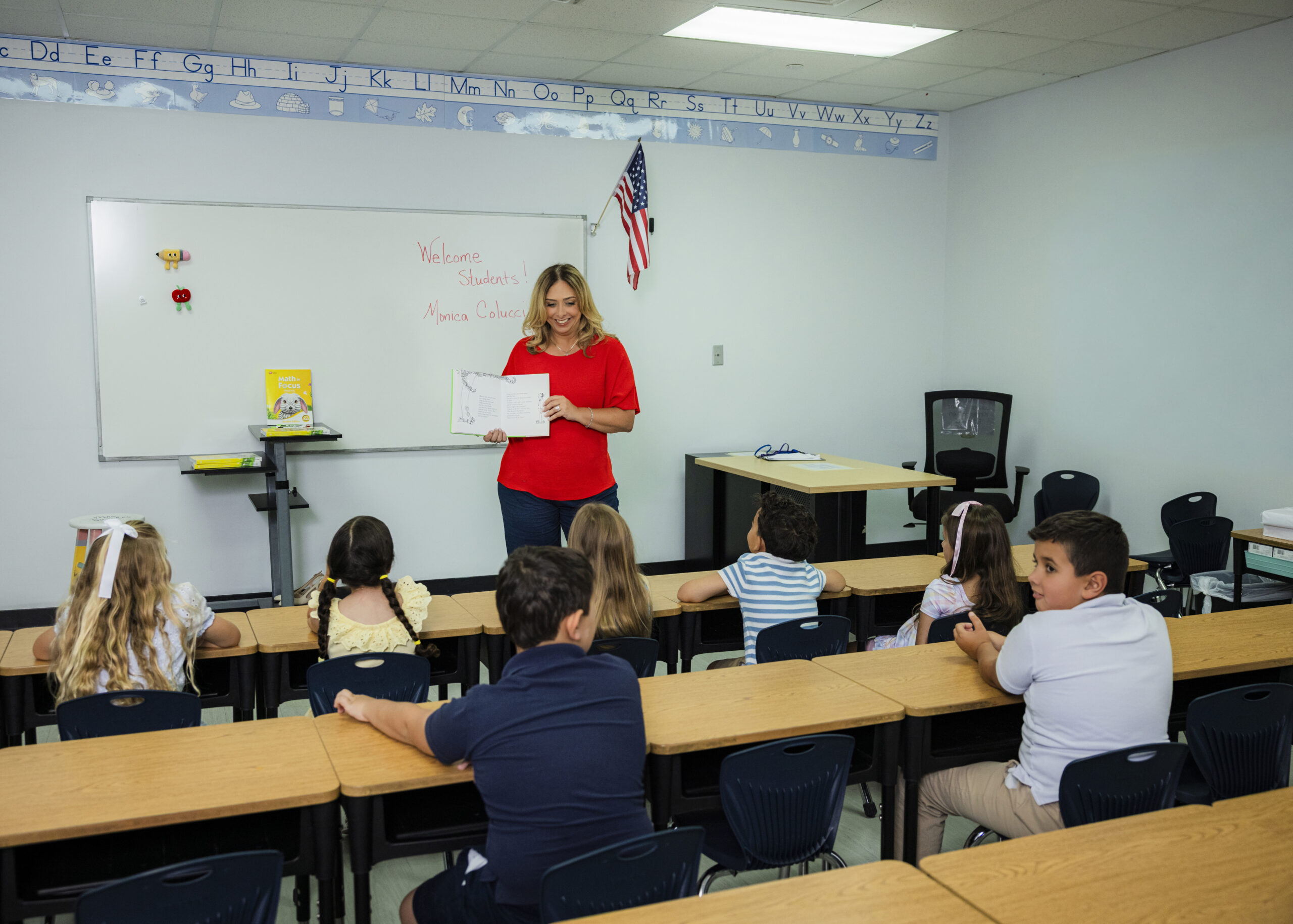 Woman speaking to students in a classroom