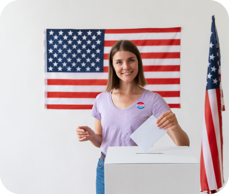 Student standing in front of American flags